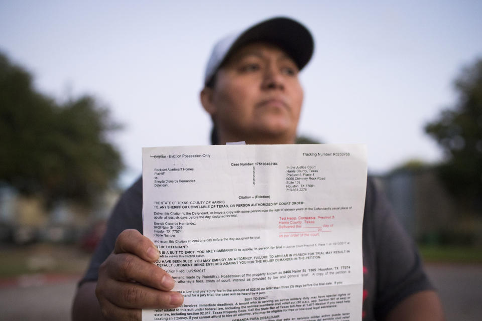 Eneyda Cisneros Hernandez holds an eviction citation she received from Rockport Apartments, the complex where she lives in Houston. 