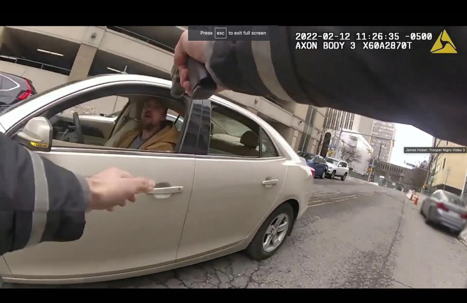 This photo taken from body cam video recorded Feb. 12, 2022, in Buffalo, N.Y., shows the hands of state trooper Anthony Nigro pointing his firearm at James Huber as he approaches Huber's car. On Monday, June 5, 2023, Nigro was charged with manslaughter for fatally shooting Huber after a high-speed car chase. (Office of the State Attorney General of New York via AP)