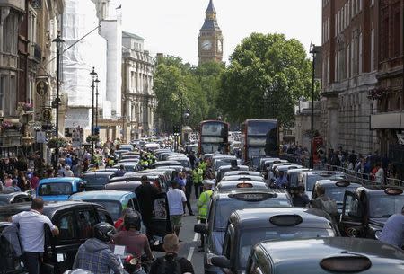 Taxi drivers block the road in Whitehall in central London June 11, 2014. REUTERS/Luke MacGregor