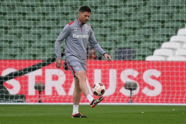 Bayer Leverkusen manager Xabi Alonso  kicks a ball in training