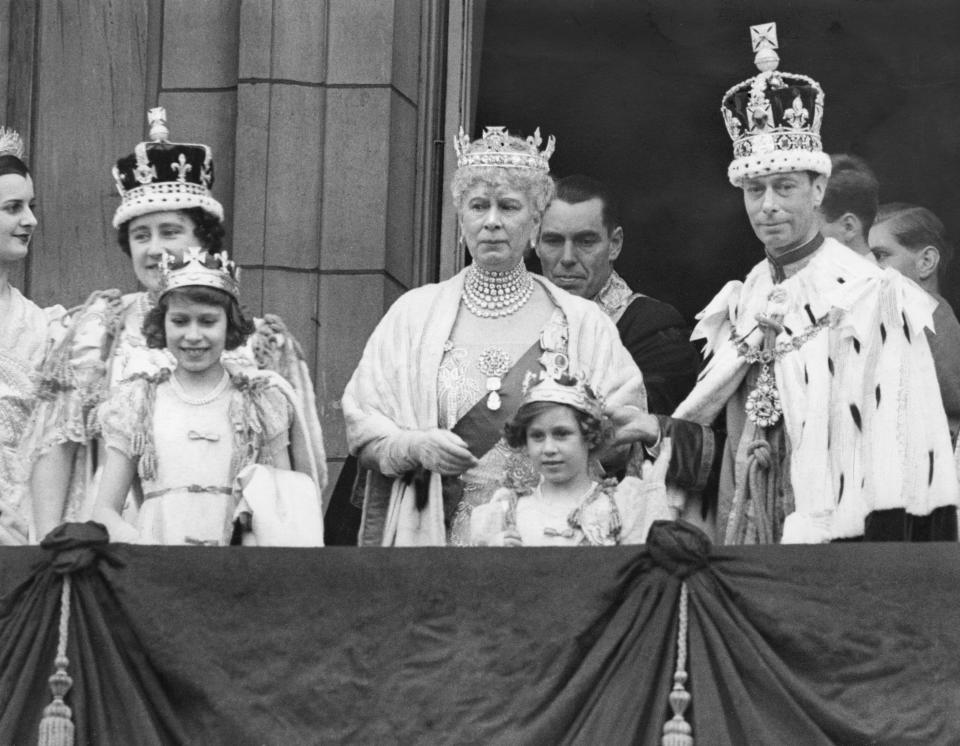 <p>Princesses Elizabeth and Margaret with their mother, the new Queen, left, and her father, the newly-crowned King George VI, right, on his coronation on 12 May 1937. Elizabeth's grandmother, Queen Mary, is in the centre. (Getty Images)</p> 