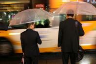 FILE PHOTO: Commuters pictured at rush hour near Shinagawa Station in Toky