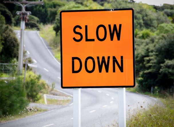 PHOTO: A warning sign advises drives to slow down on a winding rural road in a stock photo. (Georgeclerk/Getty Images)