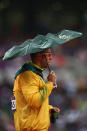 LONDON, ENGLAND - AUGUST 07: Benn Harradine of Australia shelters from the rain as he prepaes to compete in the Men's Discus Throw Final on Day 11 of the London 2012 Olympic Games at Olympic Stadium on August 7, 2012 in London, England. (Photo by Quinn Rooney/Getty Images)