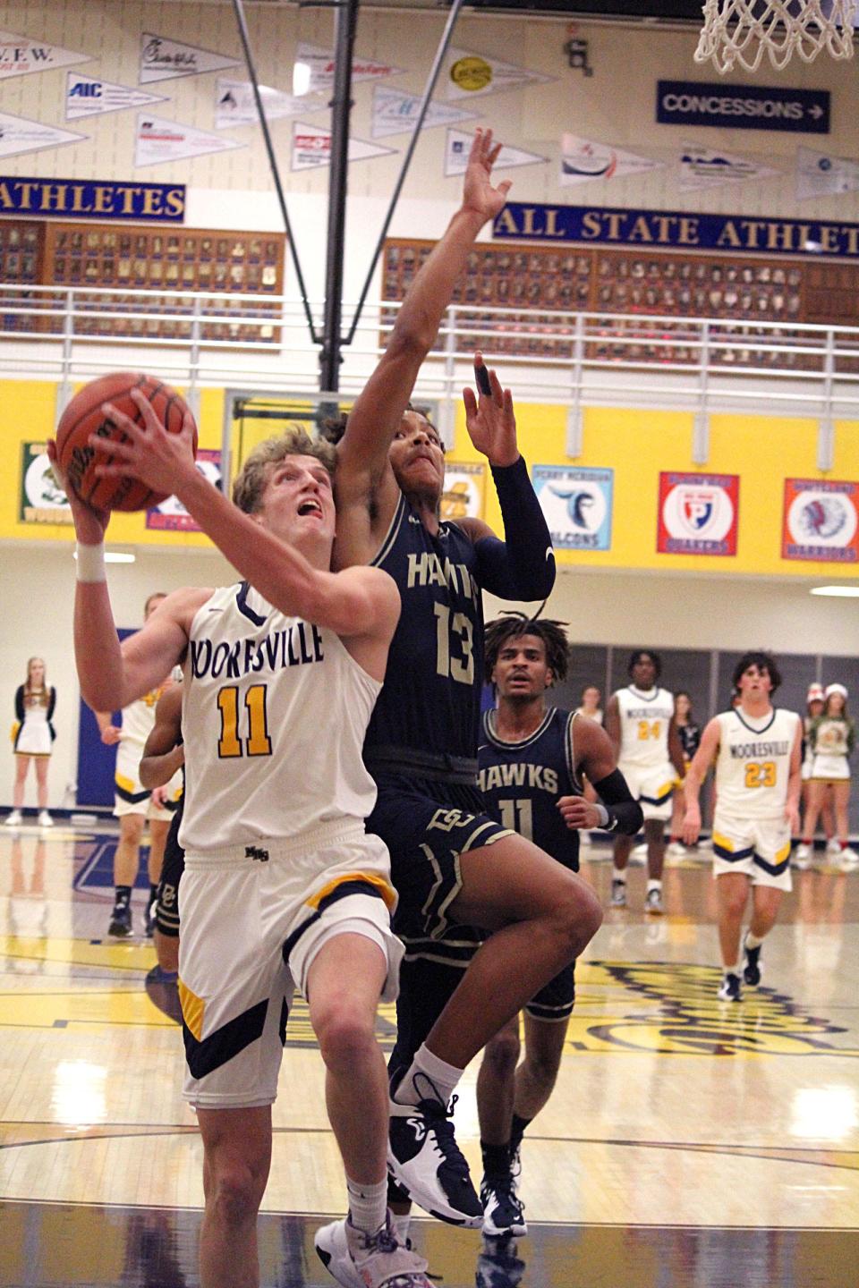 Mooresville junior Wes Reeves (11) and Decatur Central sophomore KC Berry battle under the basket during Friday's Mid-State Conference game at Mooresville. 