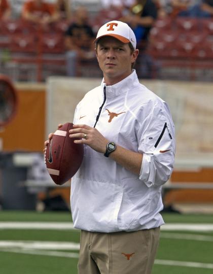 Texas offensive coordinator Major Applewhite watches players warm up before an NCAA college football game against Oklahoma State, Saturday Nov. 16, 2013, in Austin, Texas. (AP Photo/Michael Thomas)