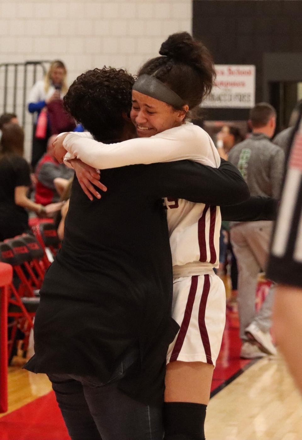 D.J. Layton embraces daugter Maya Layton following Faith Christian's sectional win over Clinton Central.