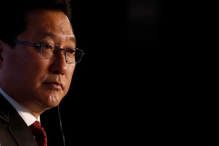 Jun Seki listens to reporters' questions during a news conference in Beijing