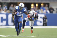 Indianapolis Colts' Marlon Mack (25) runs out of the tackle of Denver Broncos' Justin Simmons (31) during the first half of an NFL football game, Sunday, Oct. 27, 2019, in Indianapolis. (AP Photo/Michael Conroy)