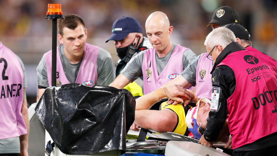 Pictured here, medical staff attend to an injured player in the 2020 AFL grand final.