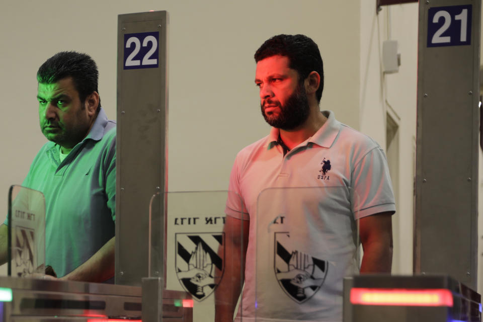 In this Thursday, July 11, 2019 photo, Palestinians stand in front of a biometric gate as they enter Israel at the Qalandia crossing in Jerusalem. Israel’s military has invested tens of millions of dollars to upgrade West Bank crossings and ease entry for Palestinian workers. But while the upgrades may have eased crossing for Palestinians entering Israeli daily for work, critics say they are a sign of the ossification of Israel’s 52-year occupation of the West Bank and slam the military’s use of facial recognition technology as problematic. (AP Photo/Sebastian Scheiner)