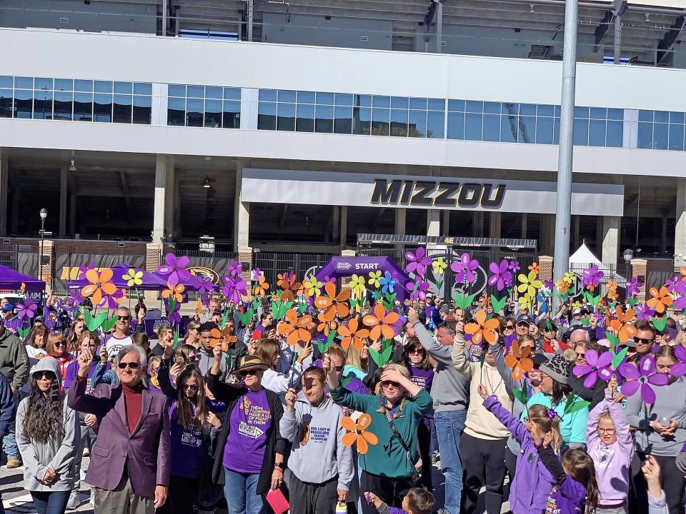Teams take part in a promise garden ceremony at the opening of the 2022 Columbia Walk to End Alzheimer's from Faurot Field at Memorial Stadium.