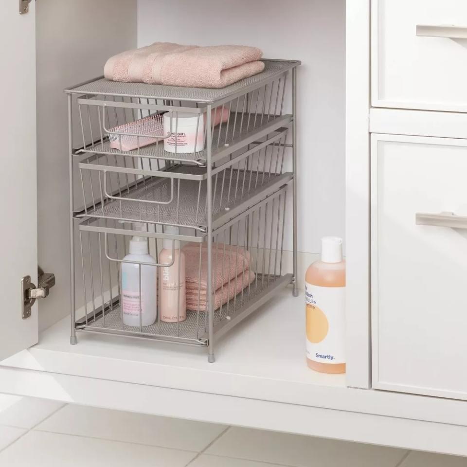 the sliding drawers in a bathroom cabinet