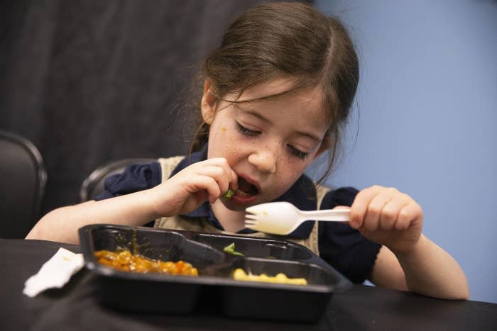 A kindergartner tastes the new school lunches made by City Fresh Food at the Boston Haley Pilot School in Roslindale on September 16, 2022 in Boston, Massachusetts.