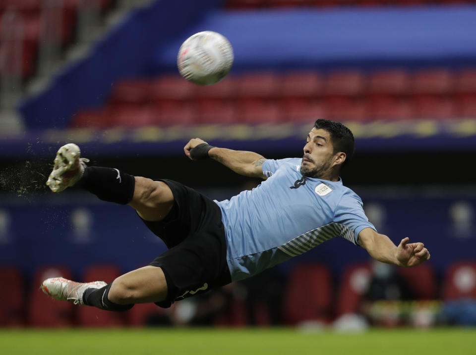 Uruguay's Luis Suarez takes a shot in an attempt to score during a Copa America soccer match against Argentina at the National Stadium in Brasilia Brazil, Friday, June 18, 2021. (AP Photo/Eraldo Peres)