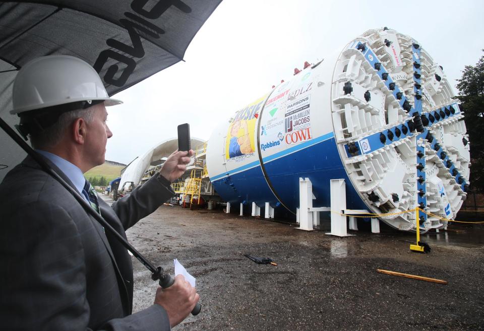 Akron Mayor Dan Horrigan takes a photo of Rosie, a tunnel boring machine, on May 25, 2017, at the Robbins Co. in Solon, Ohio. The machine dug the Ohio Canal Interceptor Tunnel beneath downtown Akron.