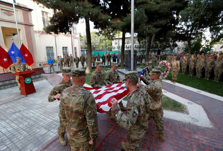 U.S. soldiers prepare to raise the American flag during a memorial ceremony to commemorate the 16th anniversary of the 9/11 attacks, in Kabul, Afghanistan September 11, 2017. REUTERS/Mohammad Ismail