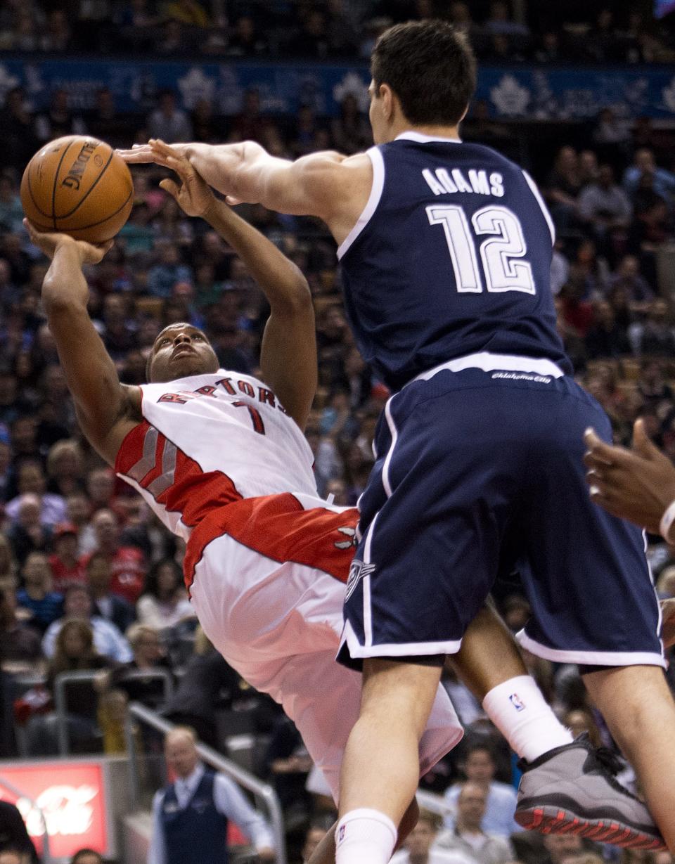 Toronto Raptors guard Kyle Lowry shoots as Oklahoma Thunder forward Steven Adams defends during the first half of an NBA basketball game in Toronto on Friday, March 21, 2014. (AP Photo/The Canadian Press, Nathan Denette)