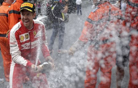 Ferrari Formula One driver Sebastian Vettel of Germany sprays champagne after getting the second place in the Monaco F1 Grand Prix May 24, 2015. REUTERS/Max Rossi