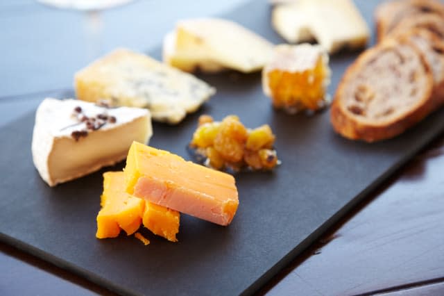 Fancy cheese plate with bread and honey