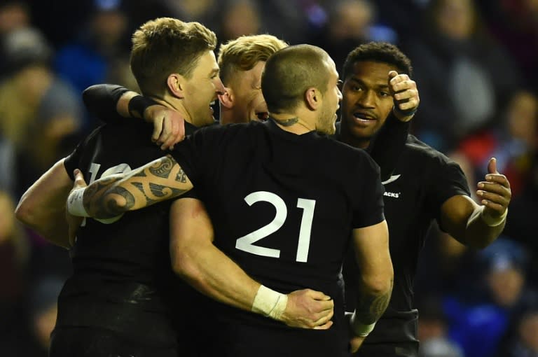 New Zealand's fly-half Beauden Barrett (L) celebrates scoring a third try with teammates during their rugby union Test match against Scotland, at Murrayfield in Edinburgh, on November 18, 2017