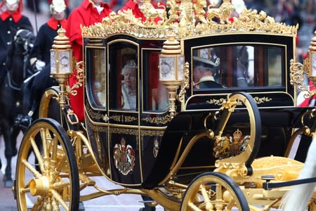 Britain's Queen Elizabeth is driven by carriage as she returns to Buckingham Palace after delivering the State Opening of Parliament in London