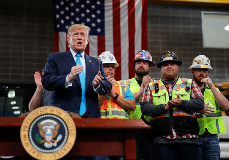 U.S. President Donald Trump is applauded prior to signing an executive order on energy and infrastructure during a campaign event at the International Union of Operating Engineers International Training and Education Center in Crosby, Texas, U.S., April 10, 2019. REUTERS/Carlos Barria