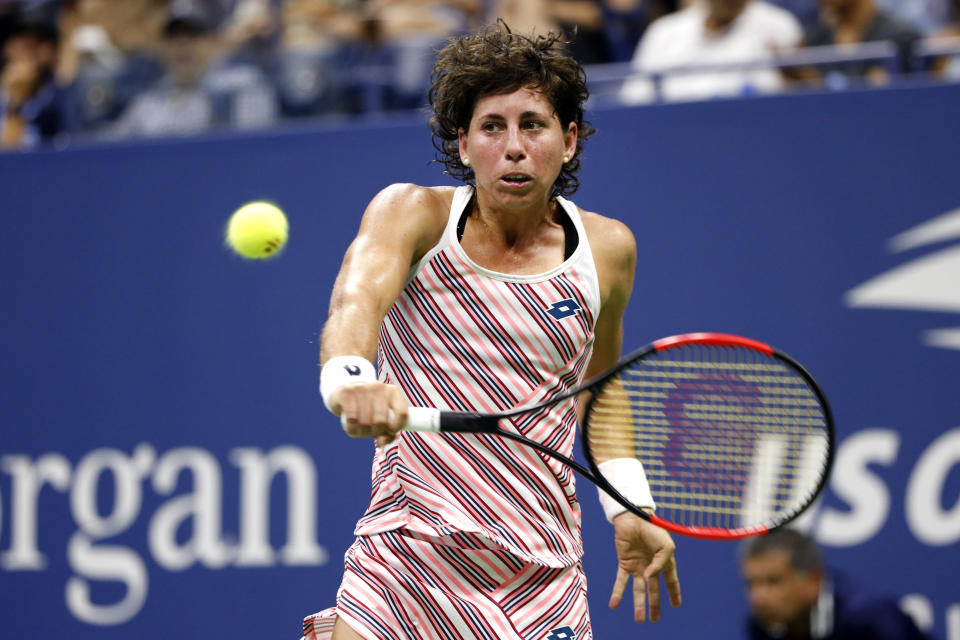 Carla Suarez Navarro, of Spain, returns a shot to Maria Sharapova, of Russia, during the fourth round of the U.S. Open tennis tournament, Monday, Sept. 3, 2018, in New York. (AP Photo/Jason DeCrow)