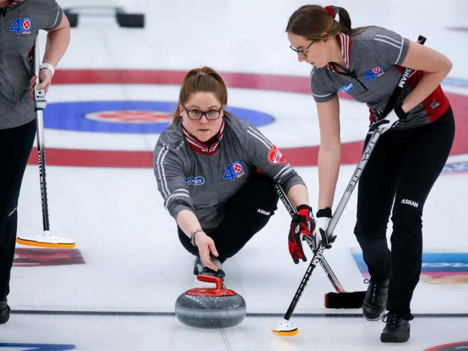 Team Northwest Territories skip Kerry Galusha, left, makes a shot against Team Wild Card 3 as second Margot Flemming sweeps at the Scotties Tournament of Hearts in Calgary, Alta., Thursday, Feb. 25, 2021. (The Canadian Press - image credit)