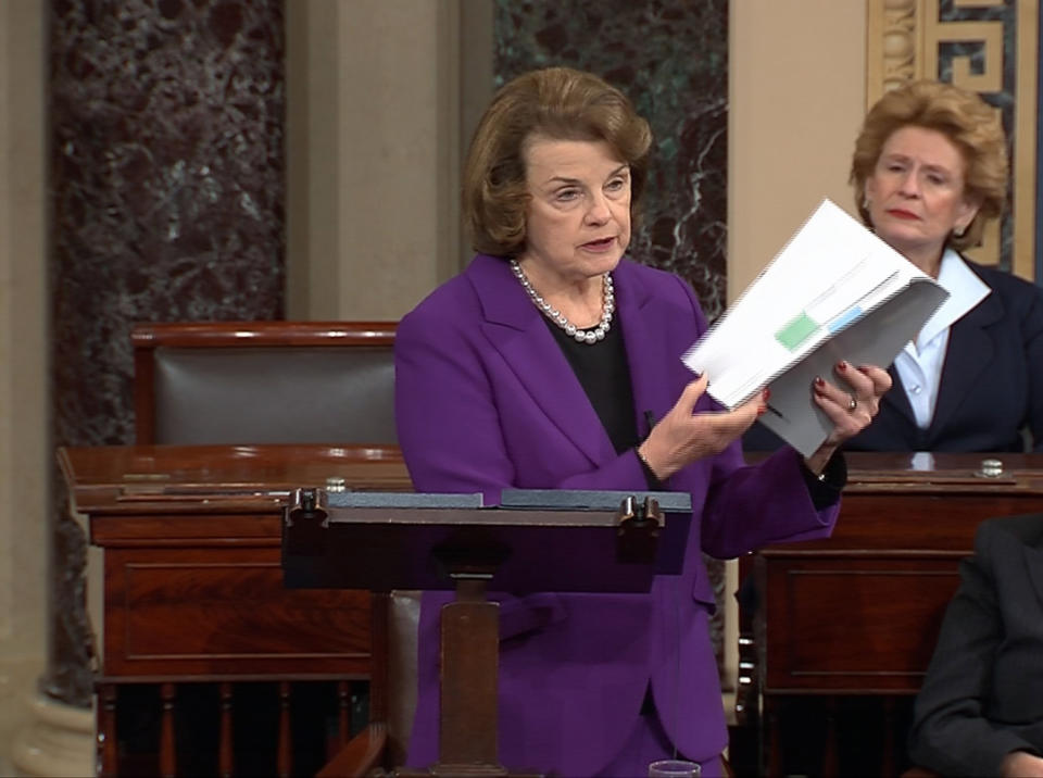 Senate Intelligence Committee Chairwoman Dianne Feinstein holding a comprehensive report as she speaks on the floor of the Senate.