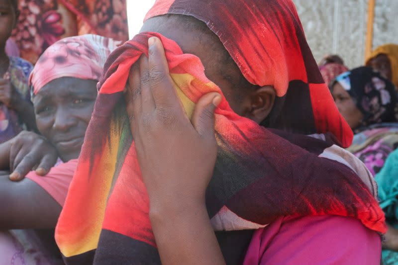 Women from the West Darfur cry after receiving the news about the death of their relatives, in Chad