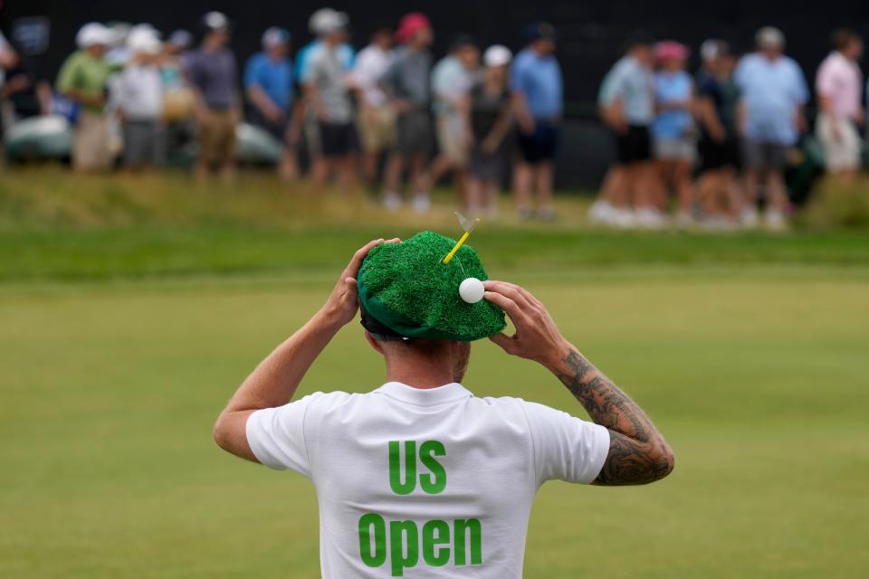 Sam Groom, from England and a Rory McIlroy fan, watches along the second hole during the second round (AP)