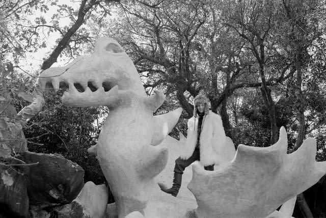 <p>Giulio Pietromarchi</p> Niki de Saint Phalle poses on her then-unfinished sculpture, Strength, in 1985.