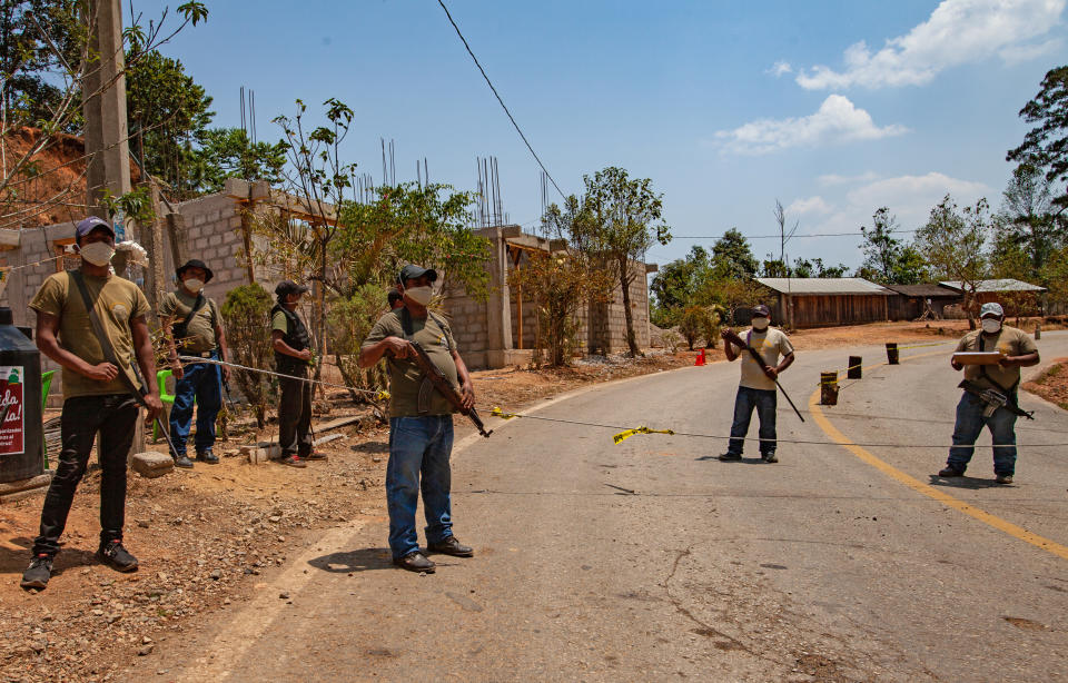 Community police in the mountain region of Malinaltepec in Mexico's Guerrero state maintain a roadblock to prevent the spread of COVID-19. (Lenin Ruwa Mosso)