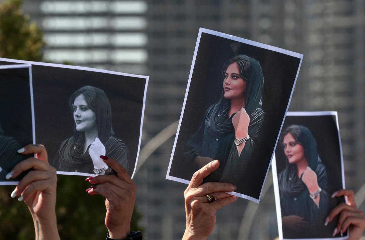 Women holding up photographs of 22-year-old Mahsa Amini during a demonstration in Arbil, the capital of Iraq's autonomous Kurdistan region, on Sept. 24, 2022. <a href="https://www.gettyimages.com/detail/news-photo/women-hold-up-signs-depicting-the-image-of-22-year-old-news-photo/1243470122?adppopup=true" rel="nofollow noopener" target="_blank" data-ylk="slk:Safin Hamed/AFP via Getty Images;elm:context_link;itc:0;sec:content-canvas" class="link ">Safin Hamed/AFP via Getty Images</a>