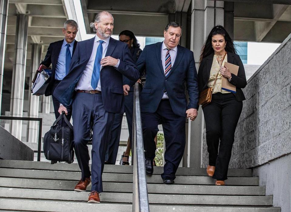 Miami City Commissioner Joe Carollo, second from right, and his wife Marjorie Carol with his lawyers Mark Sarnoff, left, and Mason Pertnoy as they leave the Broward County Federal courthouse Tuesday. It was the second day of a civil trial in which Little Havana business partners William “Bill” Fuller and Martin Pinilla sued the commissioner claiming he tried to ruin their business interests.