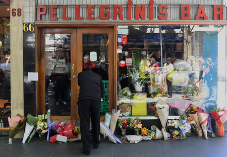 Floral tributes can be seen outside Melbourne's Pellegrini's Cafe for Sisto Malaspina, the day after he was stabbed to death in an attack police have called an act of terrorism, in central Melbourne, Australia, November 10, 2018. AAP/James Ross/via REUTERS