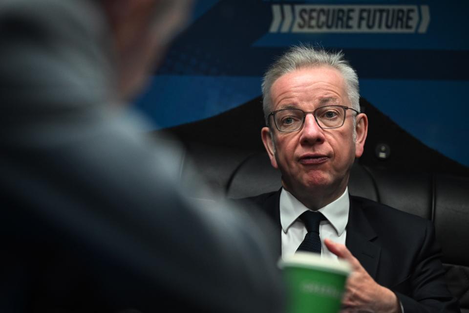 Michael Gove, Secretary of State for Levelling Up, Housing and Communities, speaks to members of his team whilst travelling on the conservative campaign bus (Getty Images)