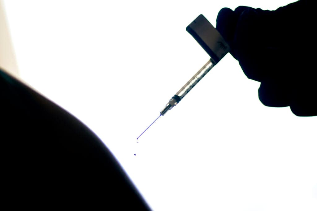 A droplet falls from a syringe after a person was injected with the Pfizer COVID-19 vaccine at a hospital in Providence, R.I. (AP Photo/David Goldman, File)