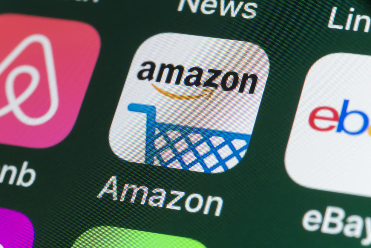 Getty Images - London, UK - July 31, 2018: The buttons of the online shopping app Amazon, surrounded by Airbnb, ebay, News and other apps on the screen of an iPhone.