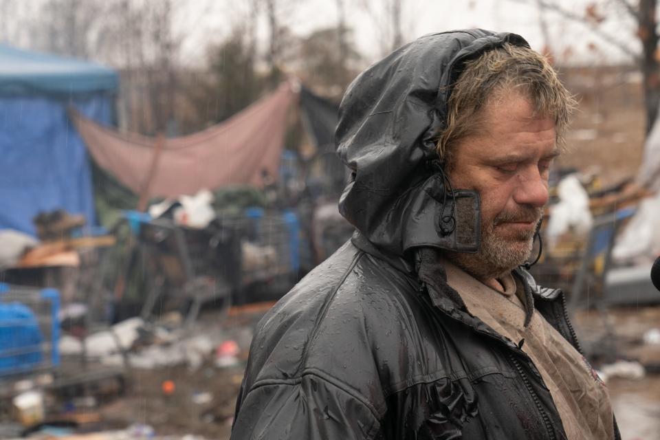 Standing in the rain amid 37-degree temperatures at his flooded campsite just south of Walmart, 1301 S.W. 37th, Larry White talks about his experiences being homeless.