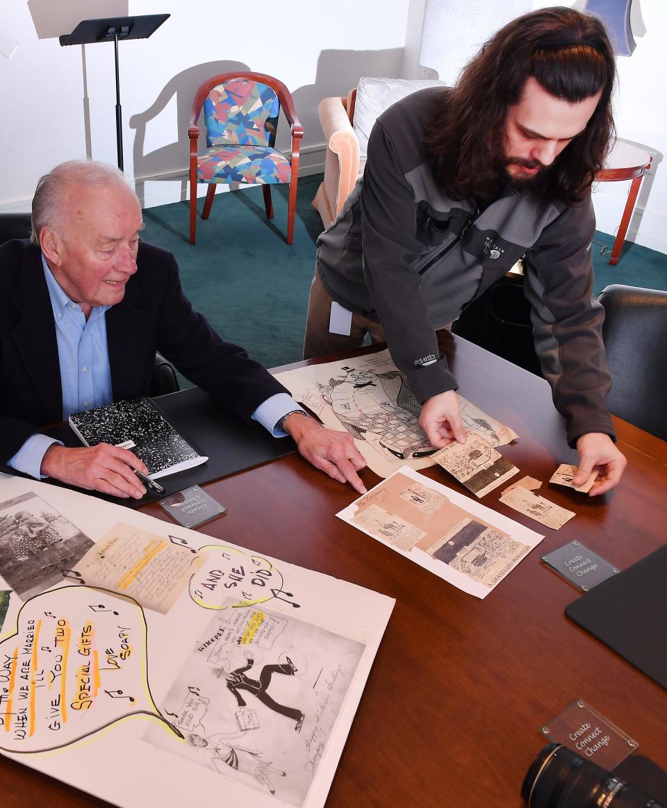 For years Lawton Wood was a cartoonist for The Spartanburg Herald Journal. Here, his son, Paul Wood, left, talks about his father's work at the Spartanburg County Headquarters Library in downtown Spartanburg on Jan. 12, 2023. Here, library processing archivist, Ian Courson, right, helps Paul Wood go through his father work.