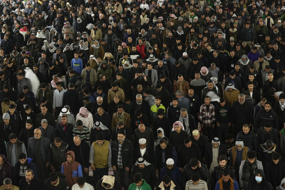 Shiite worshippers gather at the golden-domed shrine of Imam Moussa al-Kadhim, who died at the end of the eighth century, during the annual commemoration of the saint's death, in Baghdad, Iraq, Wednesday, Feb. 15, 2023. (AP Photo/Hadi Mizban)