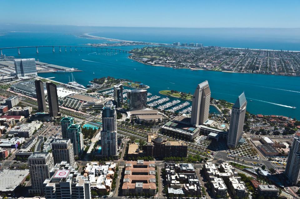 An aerial of the San Diego Convention Center with San Diego Harbor.