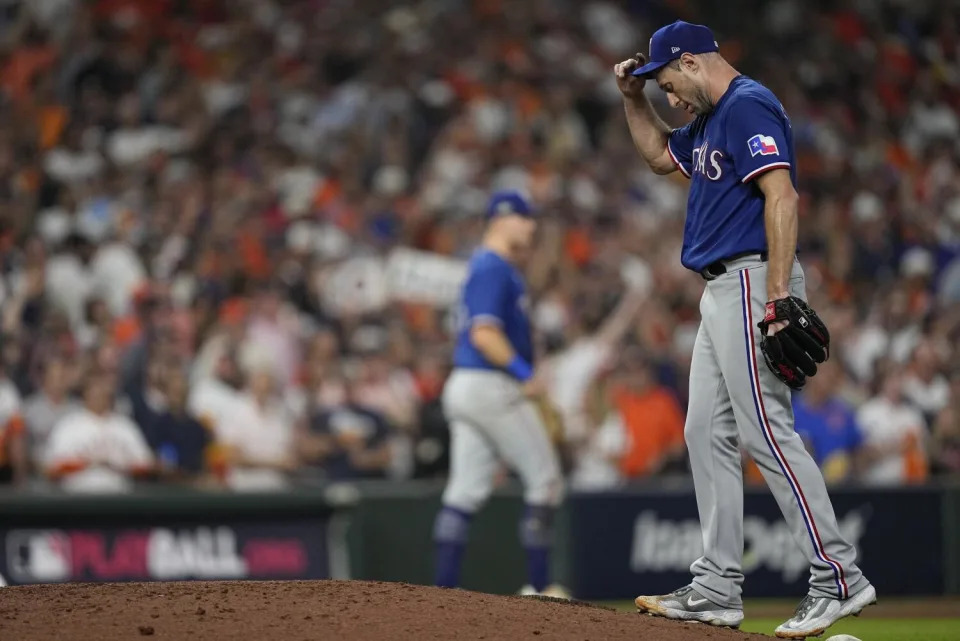 Texas Rangers pitcher Max Scherzer reacts after giving up a triple.