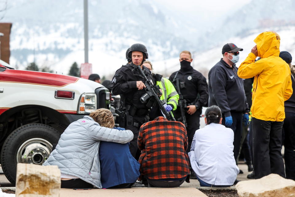 Police guard people who were evacuated after reports of an active shooter at the King Soopers grocery store in Boulder, Colo., on Monday. (Michael Ciaglo/USA Today Network via Reuters)