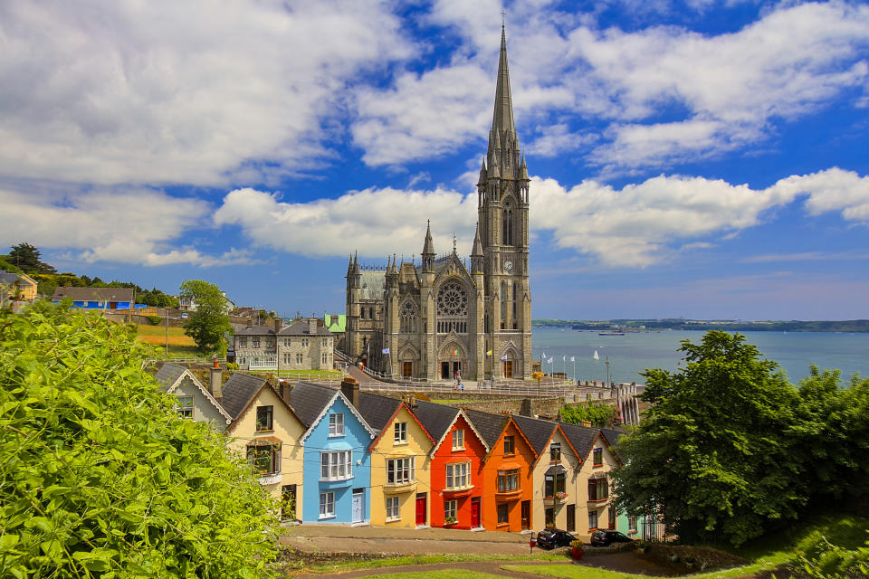 Cobh is on the south coast of County Cork, Ireland. It was the final port of call for the RMS Titanic. On a high point in the town stands St Colman's Cathedral, over a row of houses, the so-called “Deck of Cards”,  each one differs in colour from its neighbouring building.