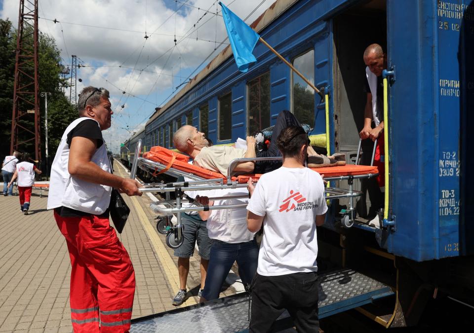 Employees of the Red Cross and Doctors Without Borders organizations take part in the evacuation by train of pensioners with heavy diseases from different settlements located close to the front line, at the railway station in Pokrovsk, Donetsk region, Ukraine, on July 18, 2022.