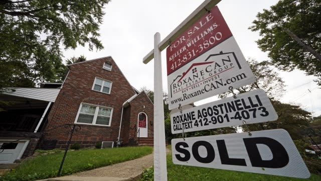 A sold sign appears in front of a home.