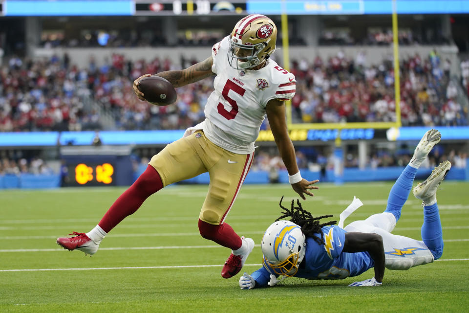 San Francisco 49ers quarterback Trey Lance (5) runs around Los Angeles Chargers defensive back Tevaughn Campbell (20) on a a failed two-point conversion attempt during the first half of a preseason NFL football game Sunday, Aug. 22, 2021, in Inglewood, Calif. (AP Photo/Ashley Landis)